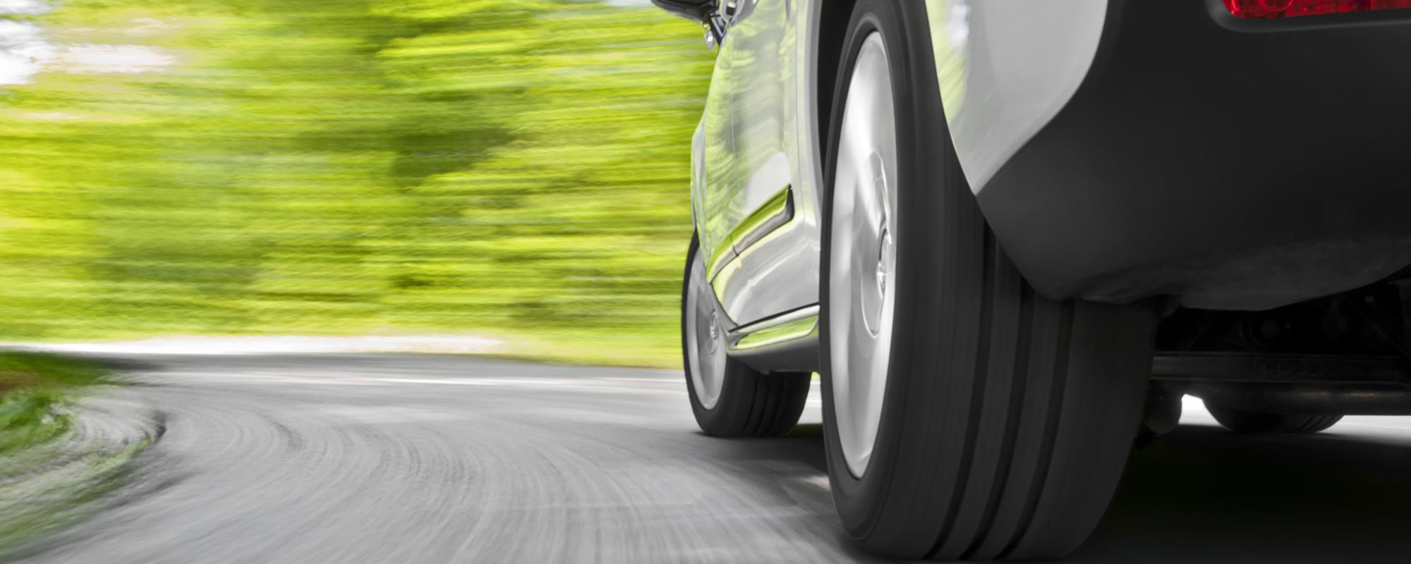 Low angle shot from the back of a car driving fast in a curveFor more car and driving images see my portfolio